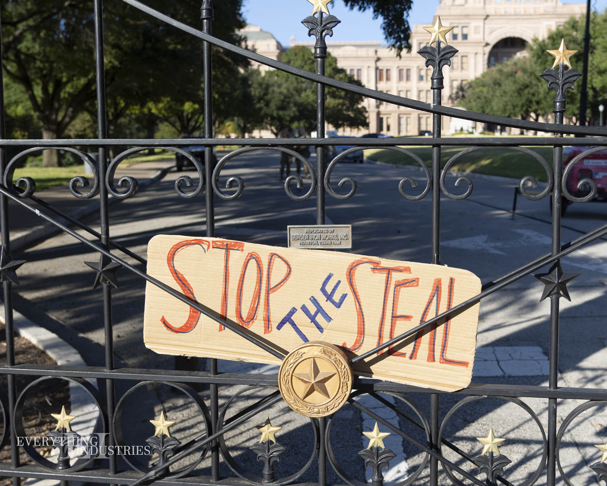 A cardboard sign stuck on the gate of Texas Capitol that says 'Stop the Steal'